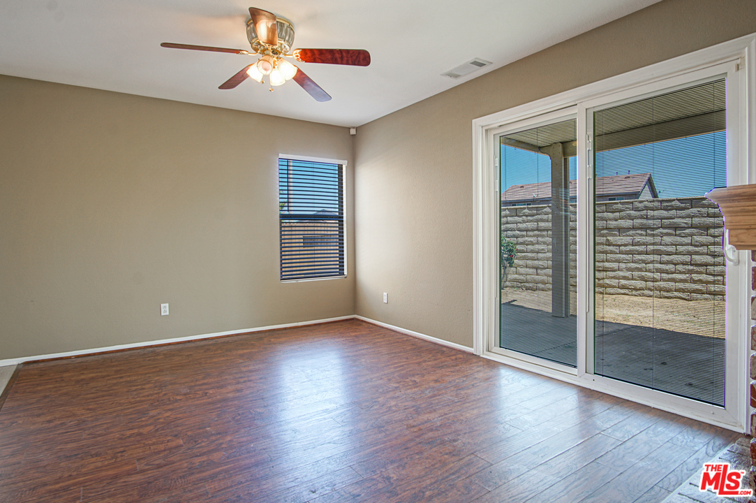 14721 Carter Road Victorville, CA 92394 - Photo 8 of 37 wooden floor in an empty room with a window