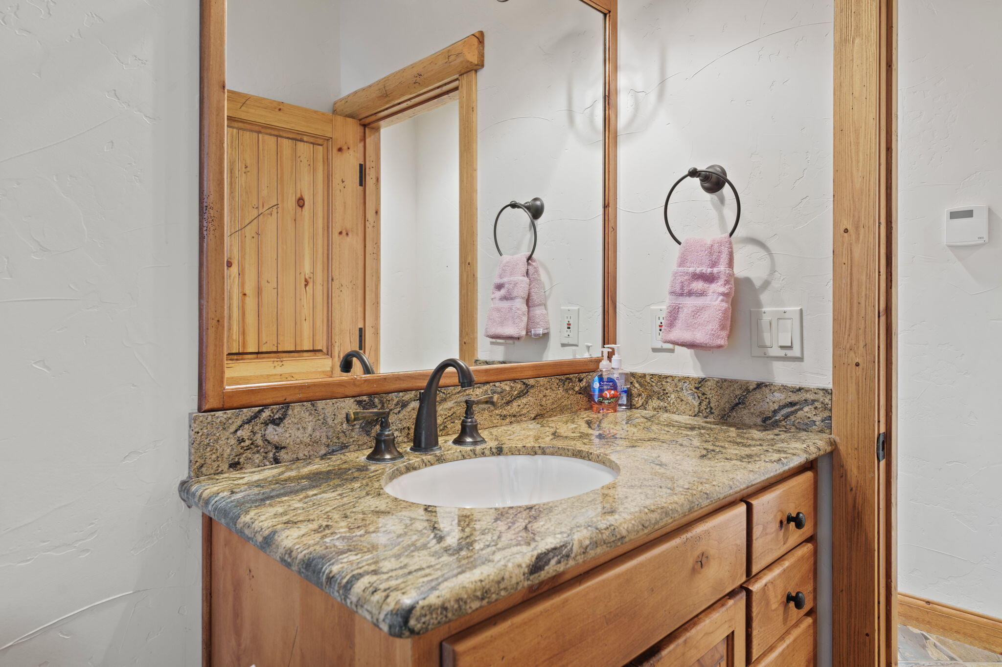 58026 Kinglet Road Sunriver, OR 97707 - Photo 23 of 39 a bathroom with sinks granite countertop a sink and a mirror