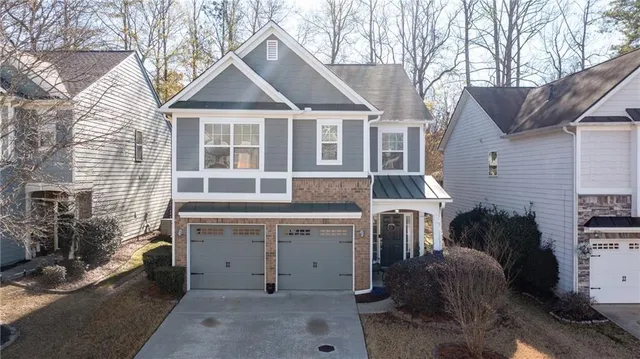 a view of a house with a yard and balcony