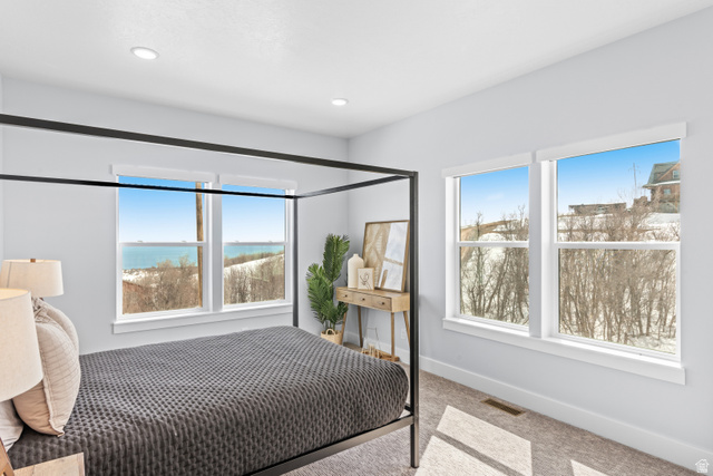 1343 North Trapper Loop Garden City, UT 84028 - Photo 6 of 56 Bedroom featuring light carpet and a water view