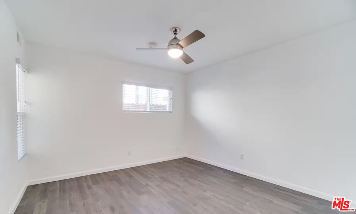16 Reef Street Marina del Rey, CA 90292 - Photo 15 of 21 an empty room with wooden floor ceiling fan and windows