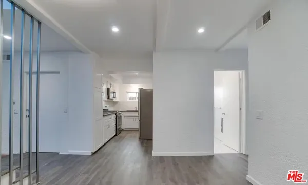 a kitchen with stainless steel appliances granite countertop a refrigerator and a stove top oven