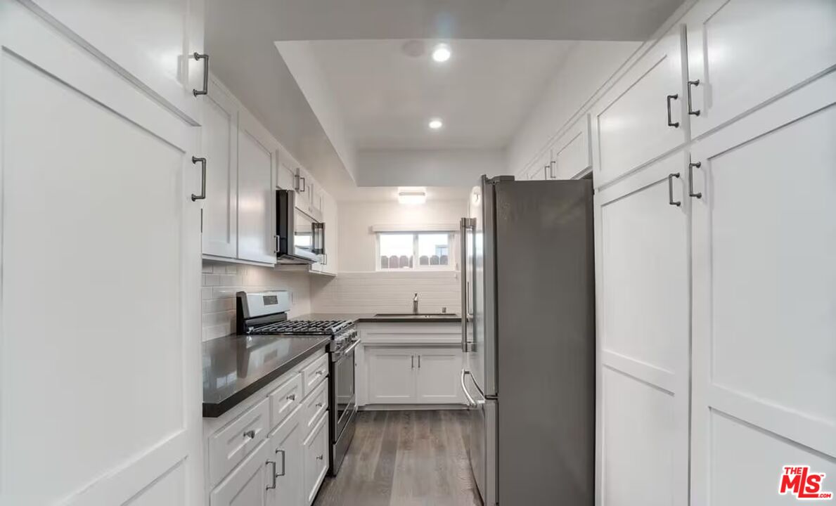16 Reef Street Marina del Rey, CA 90292 - Photo 8 of 21 a kitchen with stainless steel appliances granite countertop a refrigerator and a stove top oven