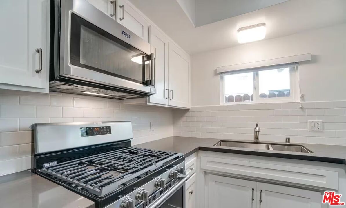 16 Reef Street Marina del Rey, CA 90292 - Photo 9 of 21 a kitchen with stainless steel appliances a stove a sink and cabinets