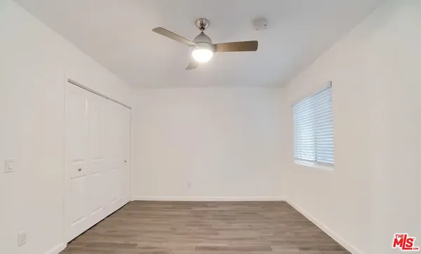 a view of a room that has a sink and a mirror