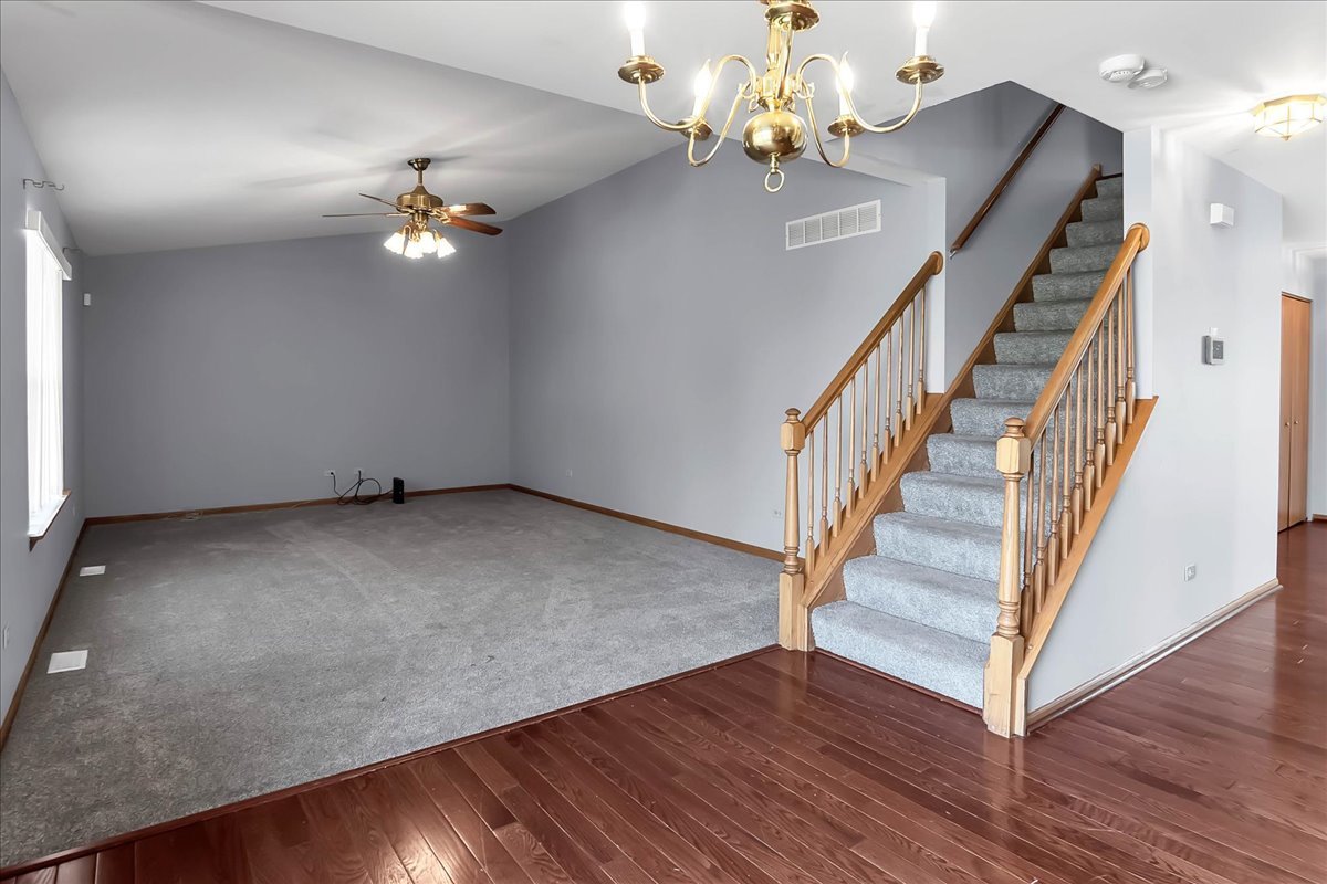 2029 Ridgemoor Drive Plainfield, IL 60586 - Photo 13 of 30 an empty room with wooden floor fan and windows