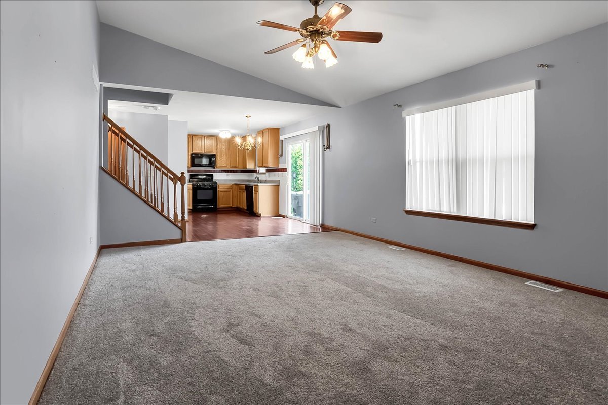 2029 Ridgemoor Drive Plainfield, IL 60586 - Photo 15 of 30 a view of a livingroom with a ceiling fan and window