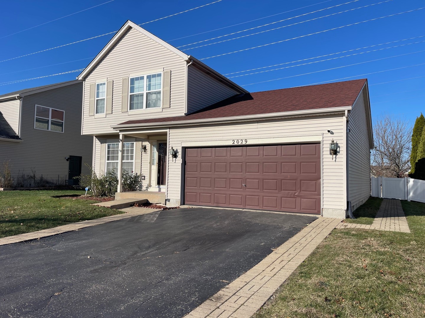 2029 Ridgemoor Drive Plainfield, IL 60586 - Photo 3 of 30 a front view of a house with a yard and garage