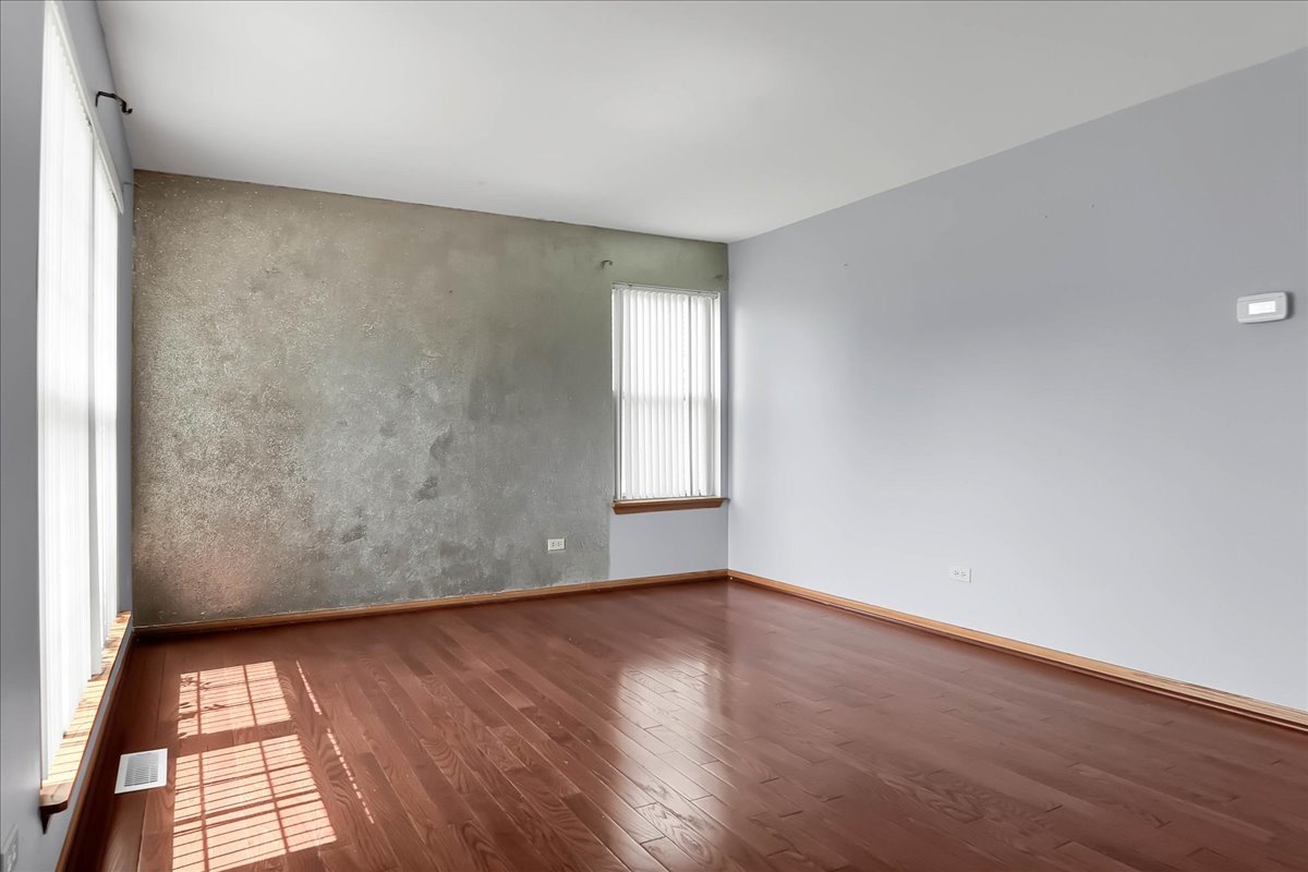 2029 Ridgemoor Drive Plainfield, IL 60586 - Photo 5 of 30 an empty room with wooden floor and windows
