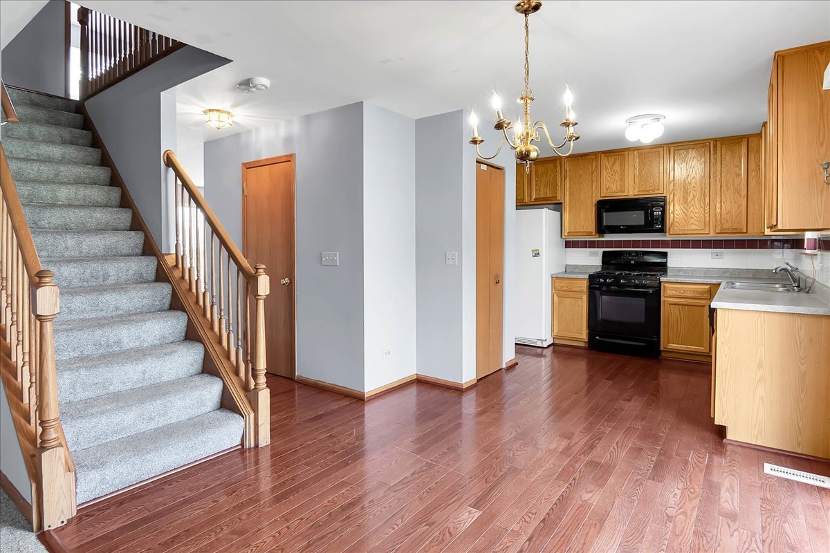 2029 Ridgemoor Drive Plainfield, IL 60586 - Photo 9 of 30 a view of a kitchen with wooden floor and stainless steel appliances