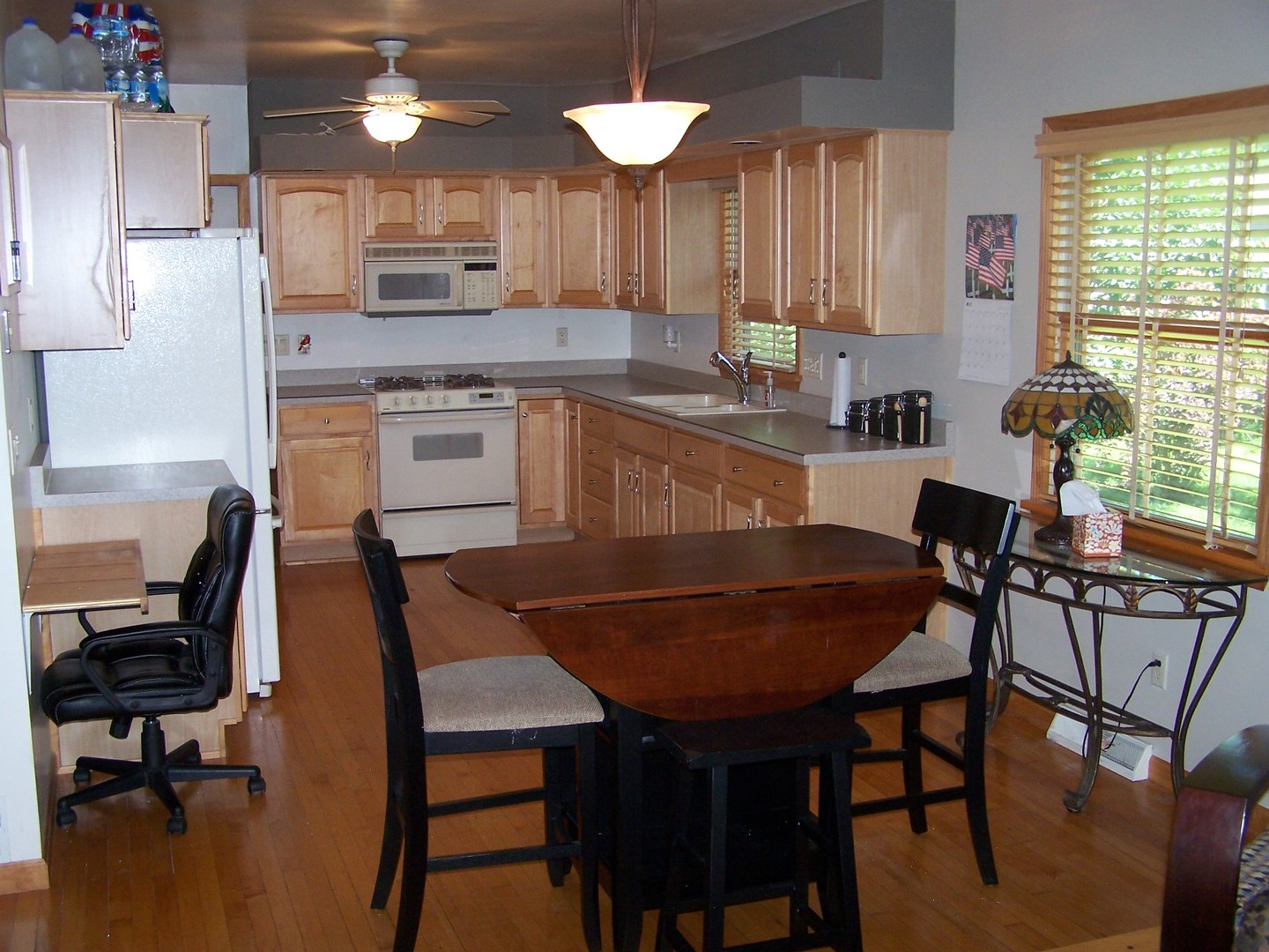 1014 Walnut Street Ottawa, IL 61350 - Photo 2 of 17 a kitchen with a dining table chairs and a sink