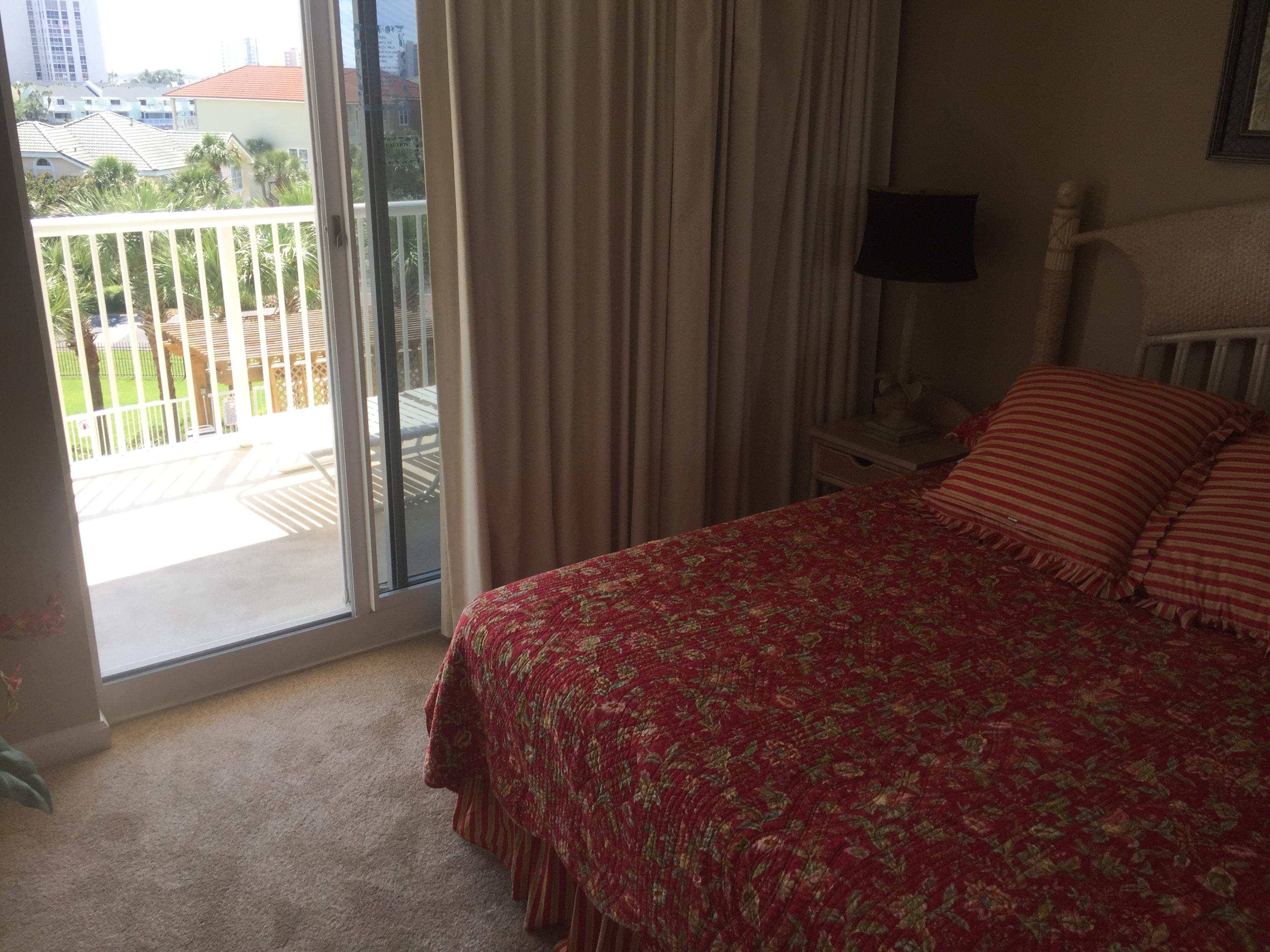 970 Highway 98, Unit 305 Destin, FL 32541 - Photo 19 of 65 a bedroom with a bed and a window