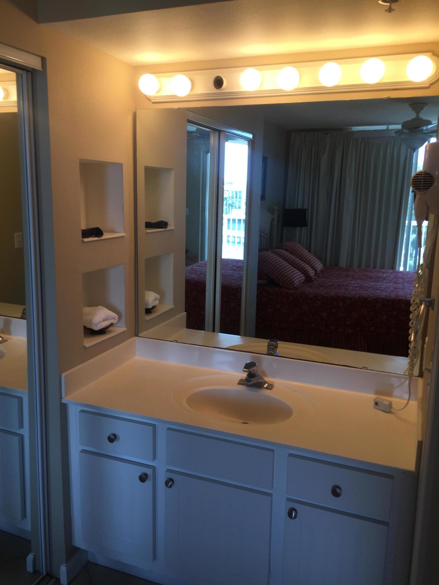 970 Highway 98, Unit 305 Destin, FL 32541 - Photo 21 of 65 a bathroom with a sink and a mirror