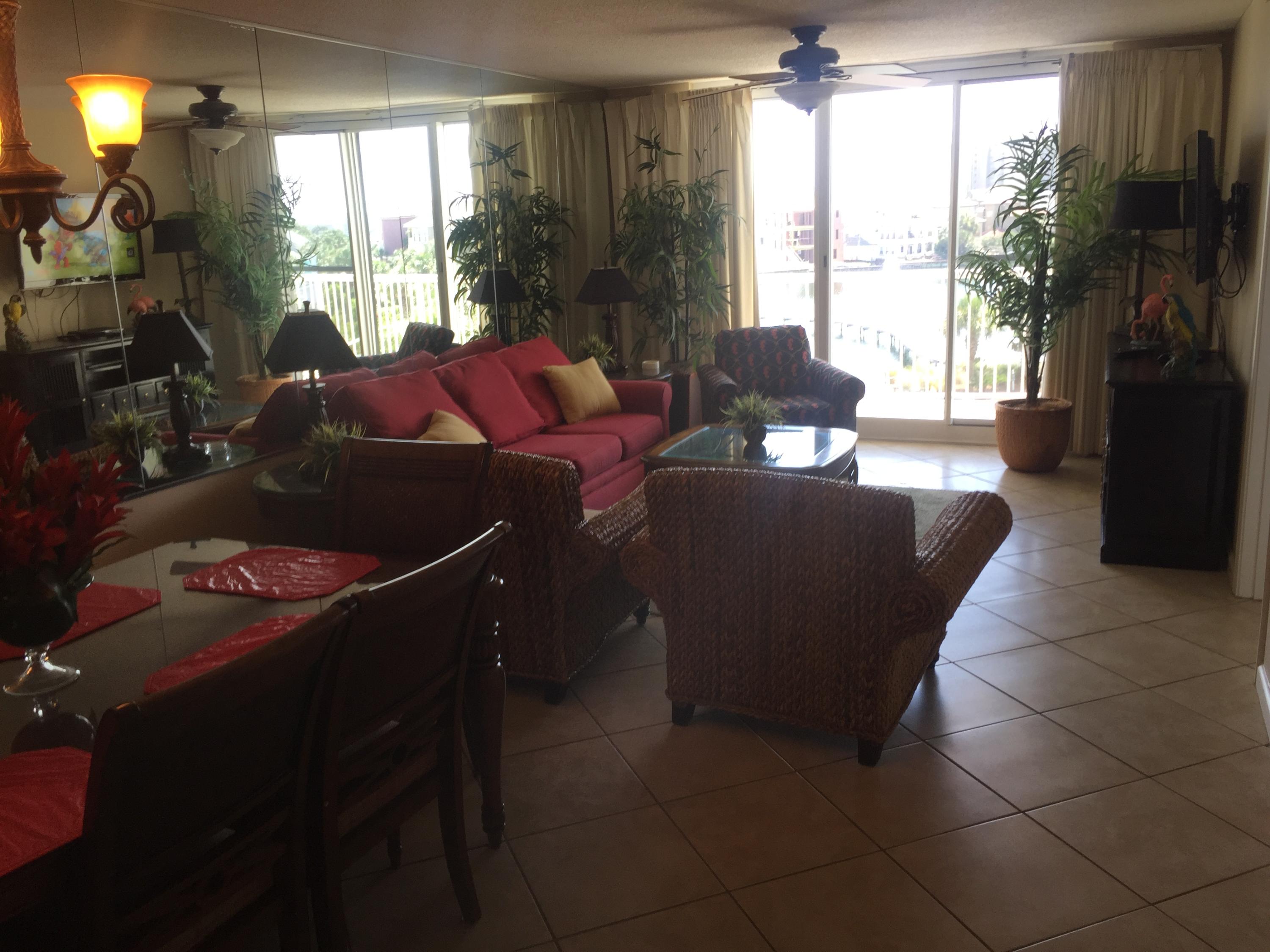 970 Highway 98, Unit 305 Destin, FL 32541 - Photo 29 of 65 a living room with furniture and a flat screen tv
