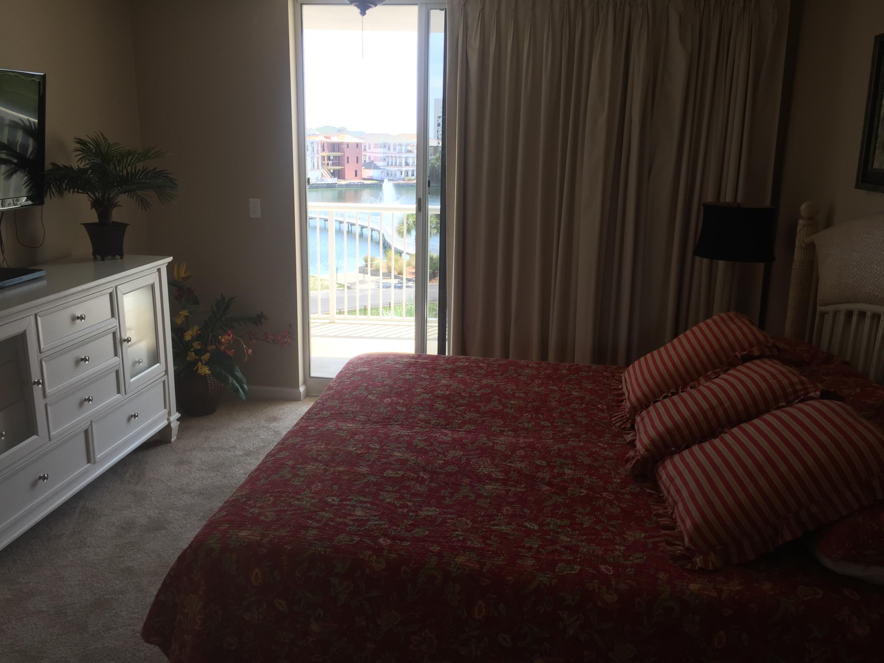 970 Highway 98, Unit 305 Destin, FL 32541 - Photo 55 of 65 a spacious bedroom with a bed and a window