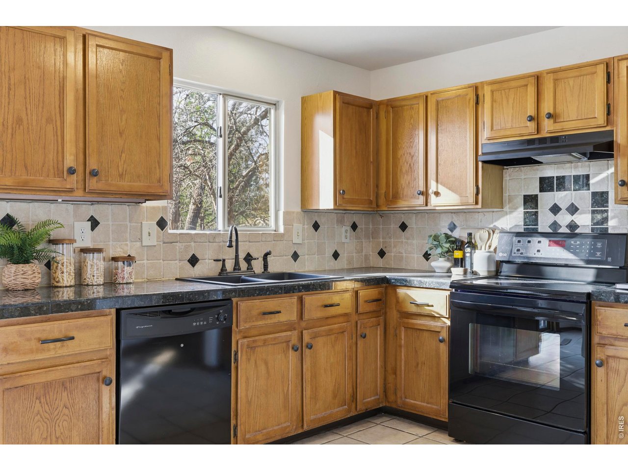 2943 Pleasant Valley Road Fort Collins, CO 80521 - Photo 13 of 38 a kitchen with stainless steel appliances granite countertop a sink stove and cabinets