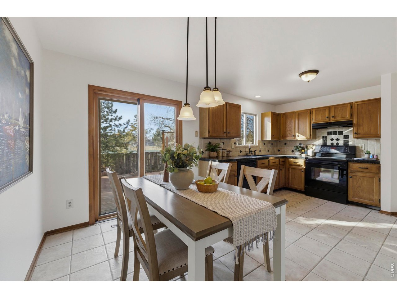 2943 Pleasant Valley Road Fort Collins, CO 80521 - Photo 14 of 38 a open dining room with stainless steel appliances kitchen island granite countertop a table chairs and a refrigerator