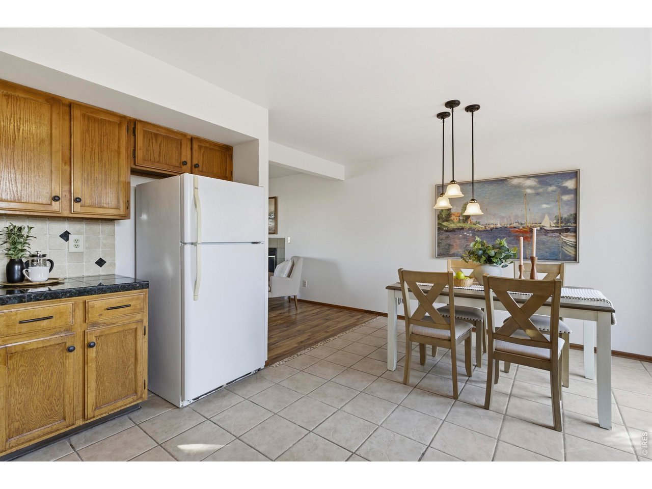 2943 Pleasant Valley Road Fort Collins, CO 80521 - Photo 10 of 38 a kitchen with a refrigerator a dining table and chairs