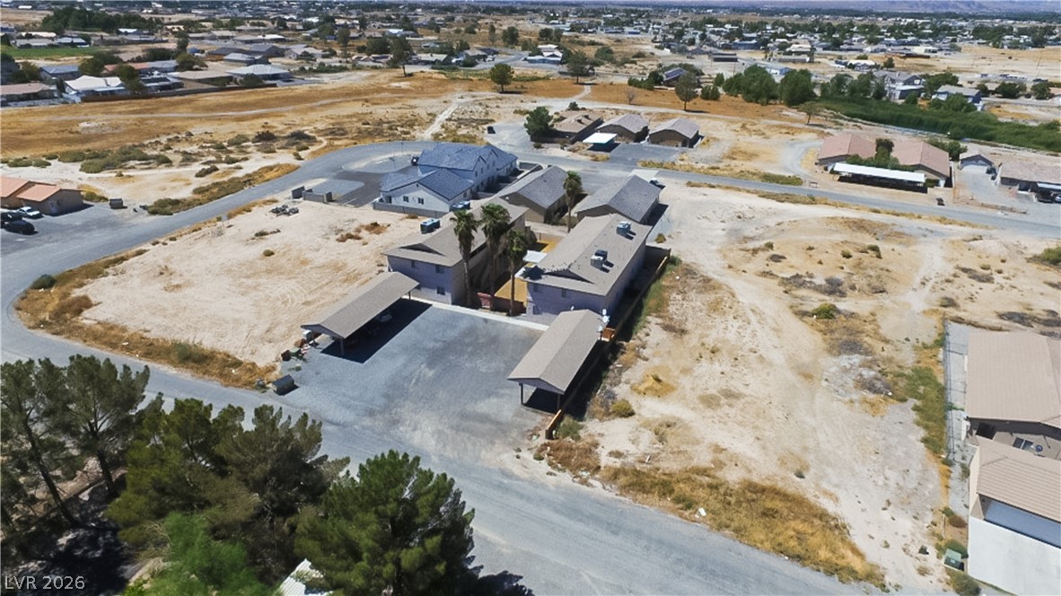 1444 Star Road Pahrump, NV 89048 - Photo 33 of 37 Aerial perspective reveals the property layout and surrounding neighborhood landscape.