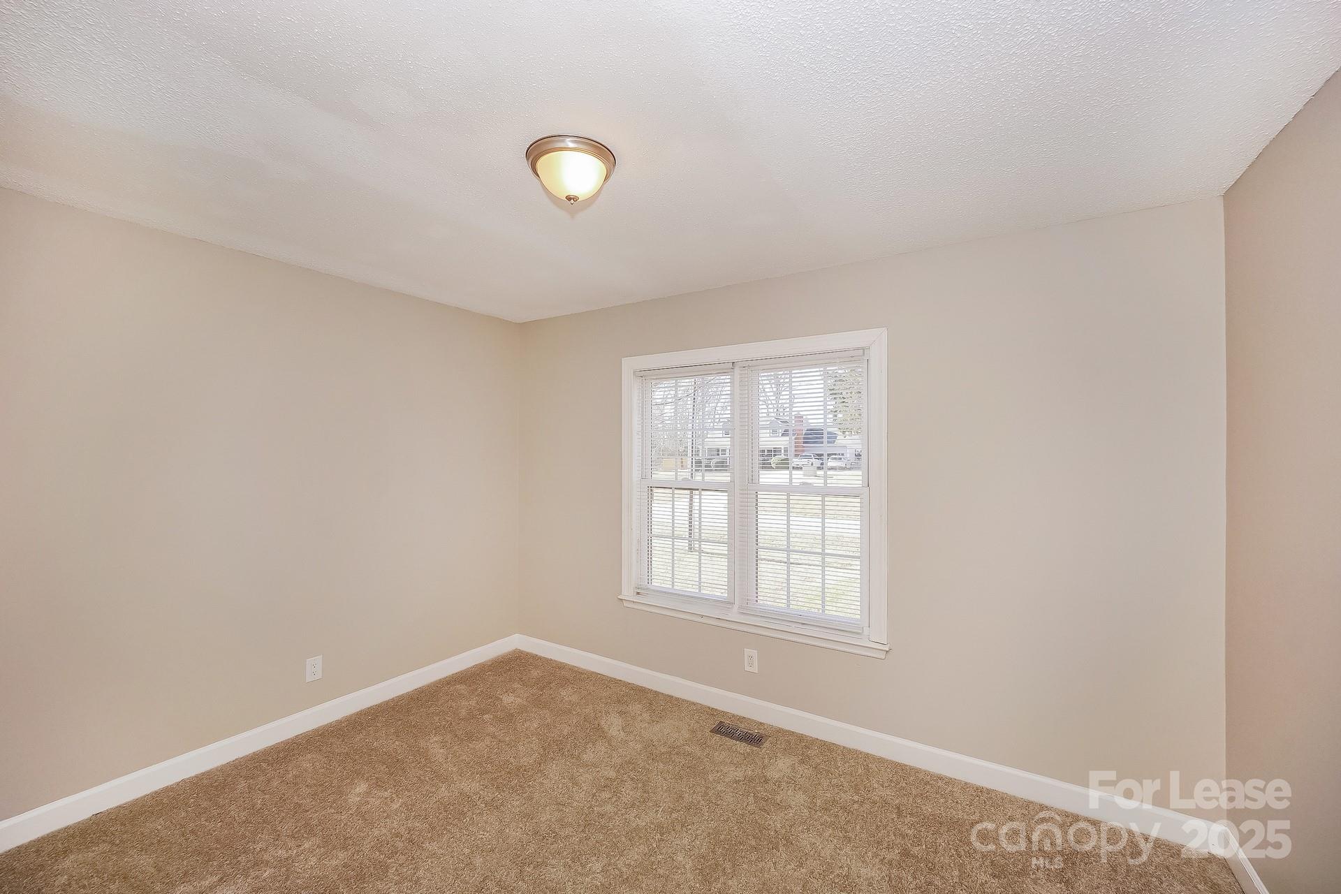 167 Mooreland Road Mooresville, NC 28117 - Photo 11 of 18 an empty room with windows