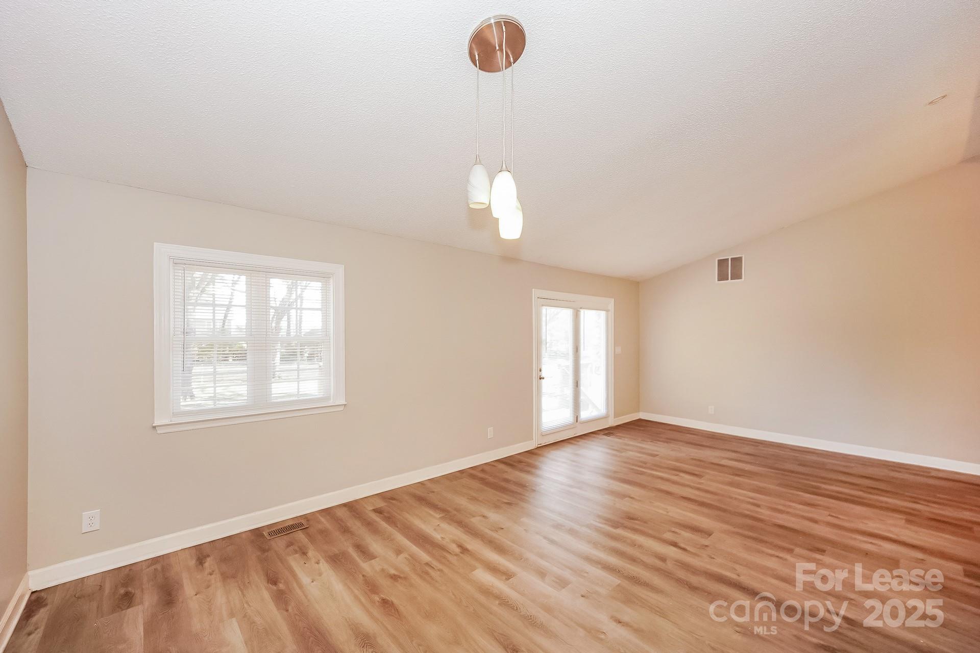 167 Mooreland Road Mooresville, NC 28117 - Photo 5 of 18 wooden floor in an empty room with a window
