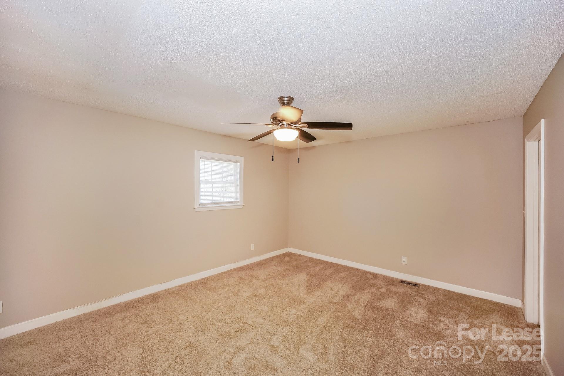 167 Mooreland Road Mooresville, NC 28117 - Photo 9 of 18 a view of a room with a ceiling fan and window