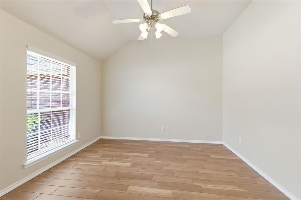 817 Huebner Way Burleson, TX 76028 - Photo 8 of 35 Formal dining room has a wood look porcelain tiled floor, huge window for natural light and vaulted ceiling.