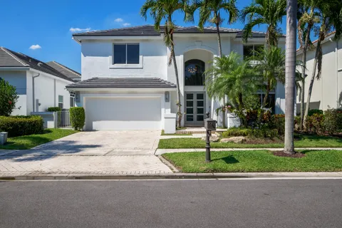 a front view of a house with a garden and plants