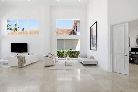 a living room with furniture tv and a window