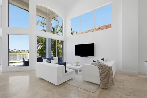 a kitchen with stainless steel appliances a table and chairs in it