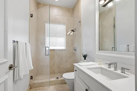 a bedroom with a large bed and a large window