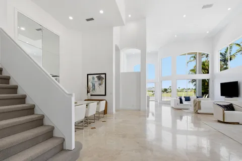 a view of a hallway with chairs and closet
