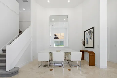 a view of a dining room with furniture and window