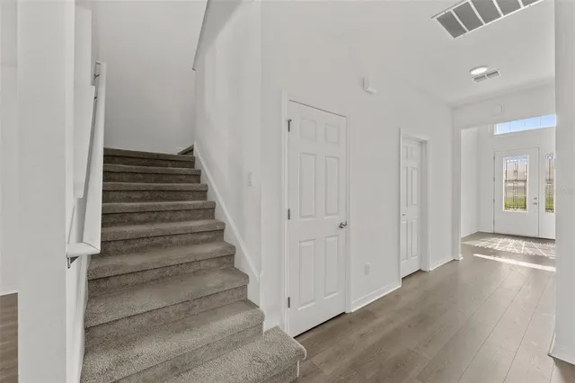 a view of an entryway with wooden floor