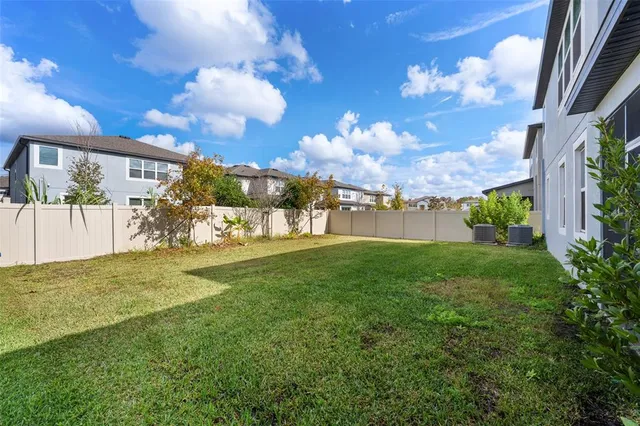 a view of a pathway of a house with a big yard
