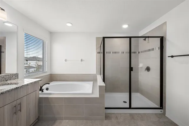 a bathroom with a bathtub and a shower
