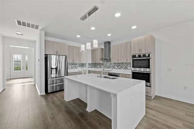 a kitchen with a sink stainless steel appliances and cabinets