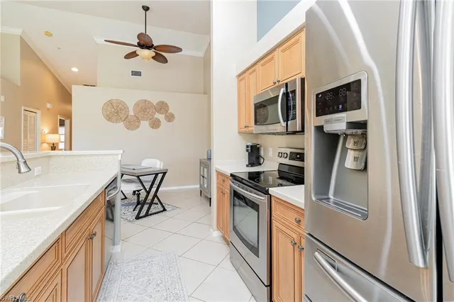 a kitchen with stainless steel appliances granite countertop a sink and a refrigerator