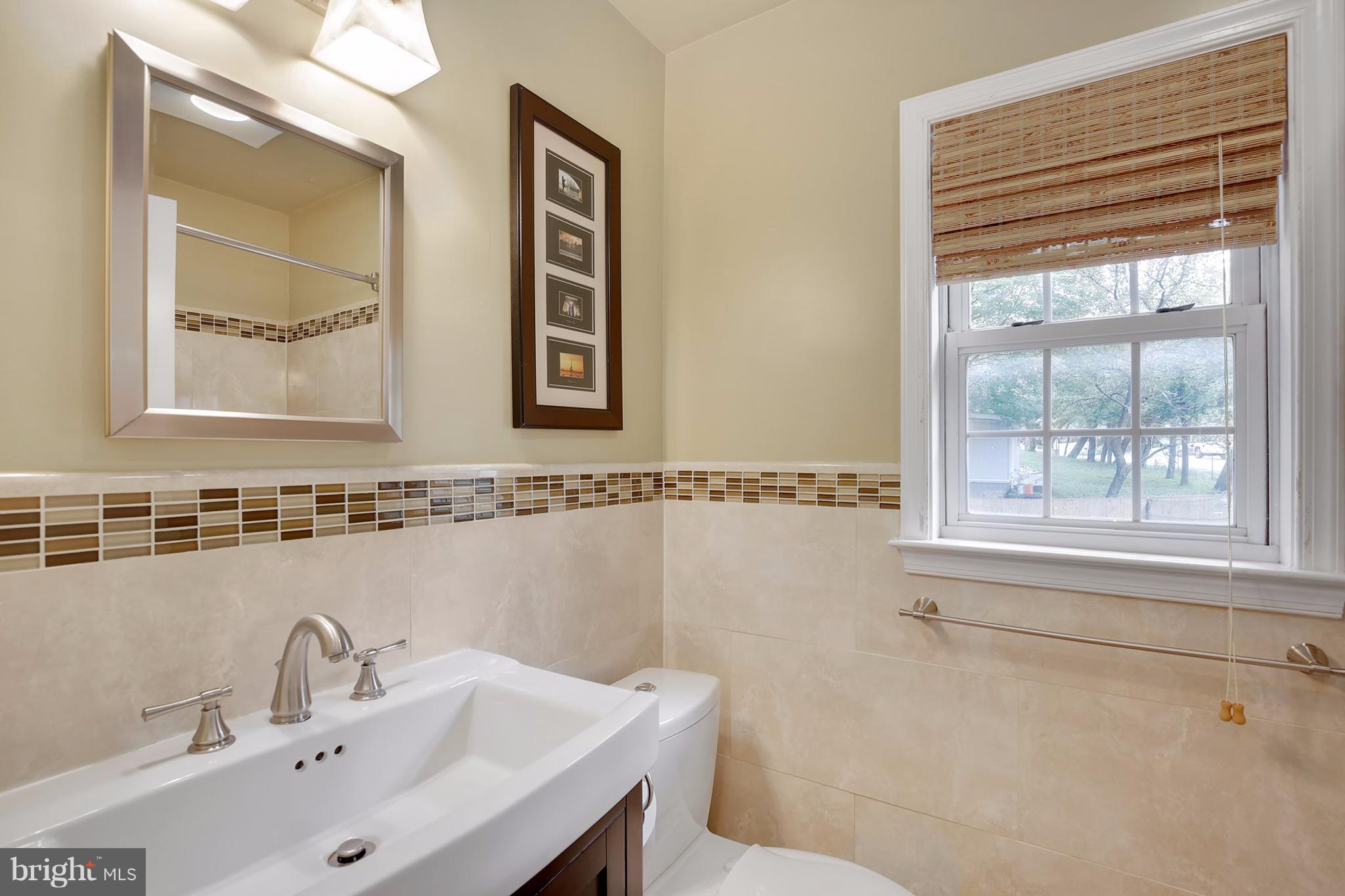 7913 Piney Branch Road Silver Spring, MD 20910 - Photo 15 of 30 a bathroom with a sink and a mirror