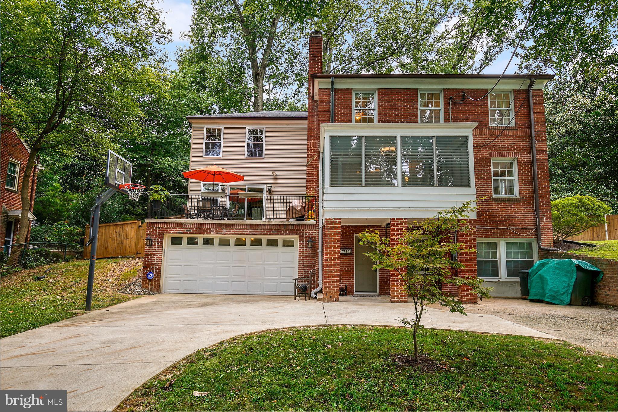 7913 Piney Branch Road Silver Spring, MD 20910 - Photo 3 of 30 a front view of a house with a yard and garage
