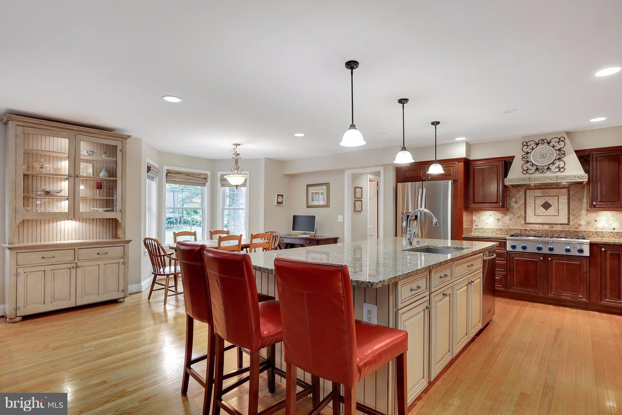 7913 Piney Branch Road Silver Spring, MD 20910 - Photo 10 of 30 a large kitchen with granite countertop a stove a sink a dining table and chairs