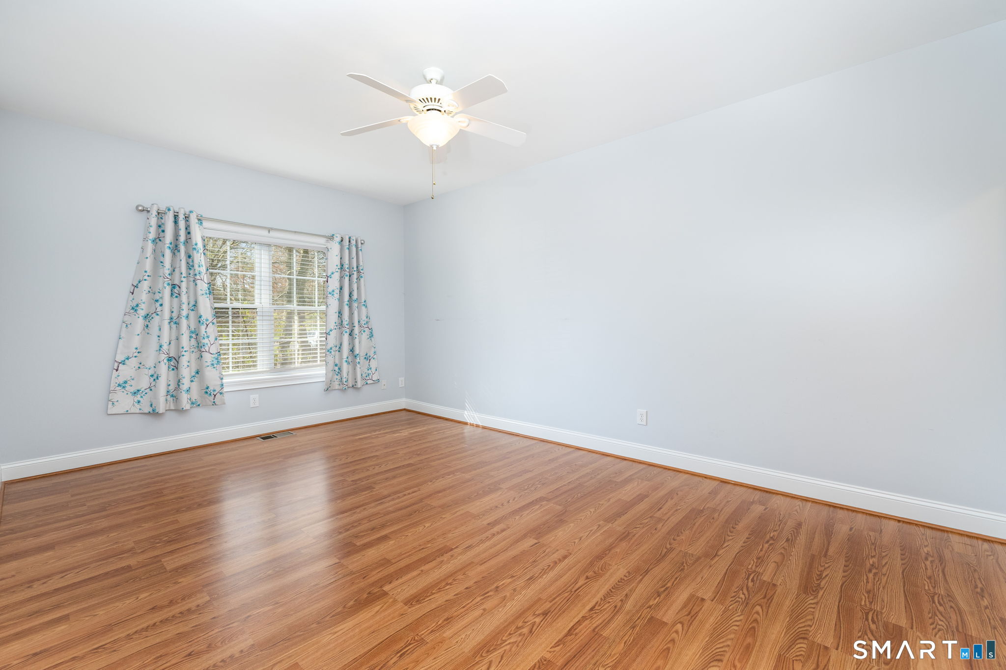66 Kristyn Circle, Unit 66 Manchester, CT 06042 - Photo 13 of 26 a view of an empty room with wooden floor and a window