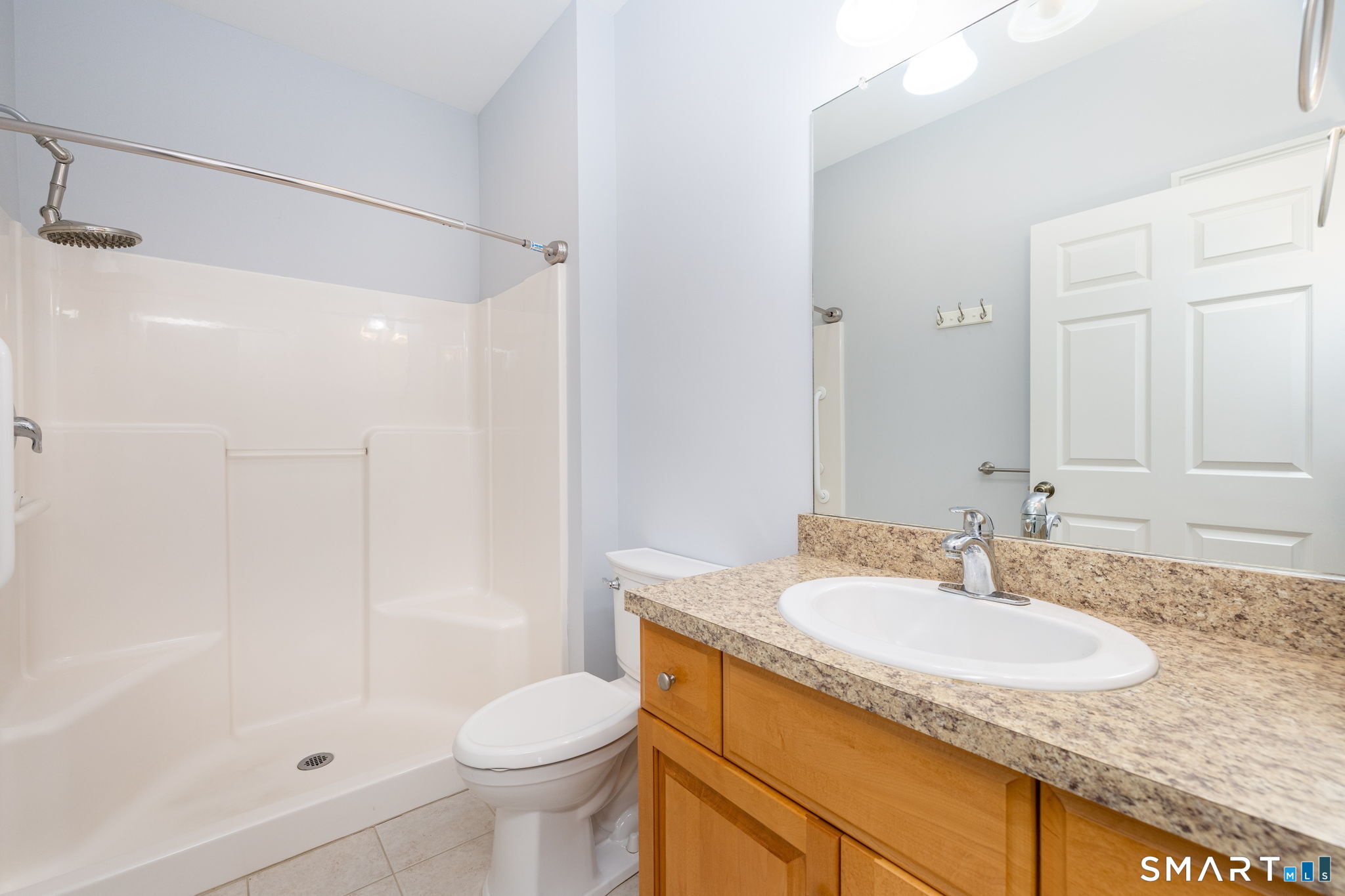66 Kristyn Circle, Unit 66 Manchester, CT 06042 - Photo 14 of 26 a bathroom with a granite countertop sink a toilet and shower