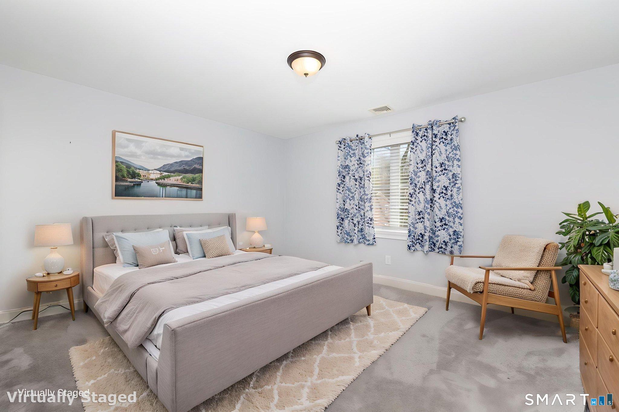 66 Kristyn Circle, Unit 66 Manchester, CT 06042 - Photo 15 of 26 a spacious bedroom with a bed and a lounge chair