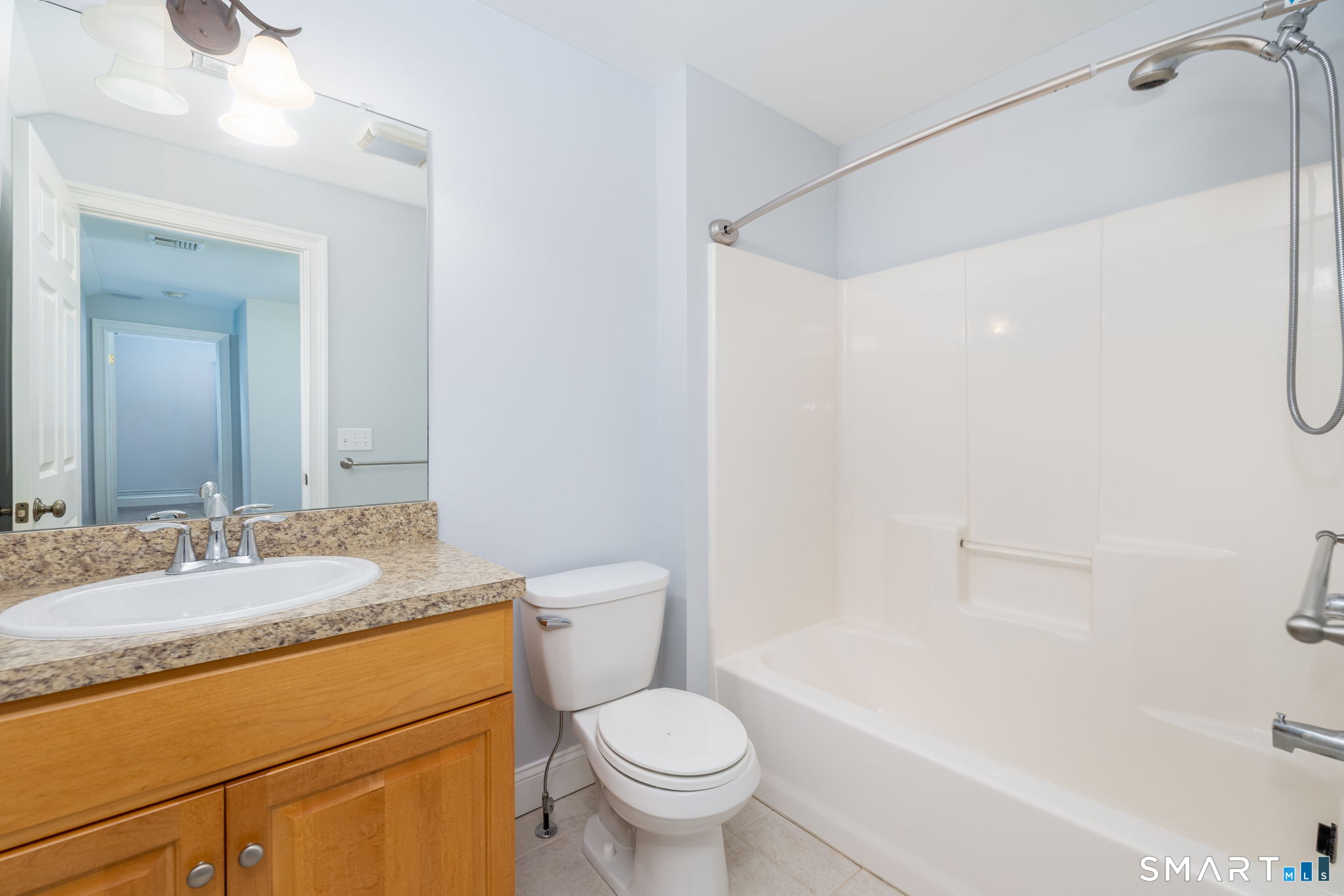 66 Kristyn Circle, Unit 66 Manchester, CT 06042 - Photo 17 of 26 a bathroom with a granite countertop sink a toilet and a bathtub