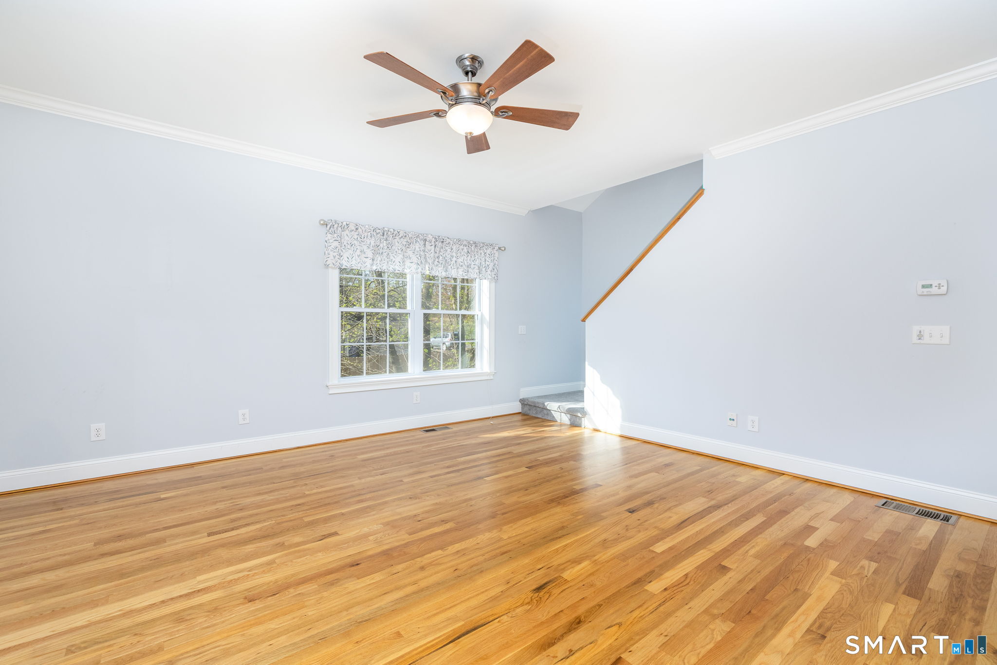 66 Kristyn Circle, Unit 66 Manchester, CT 06042 - Photo 5 of 26 an empty room with wooden floor and windows