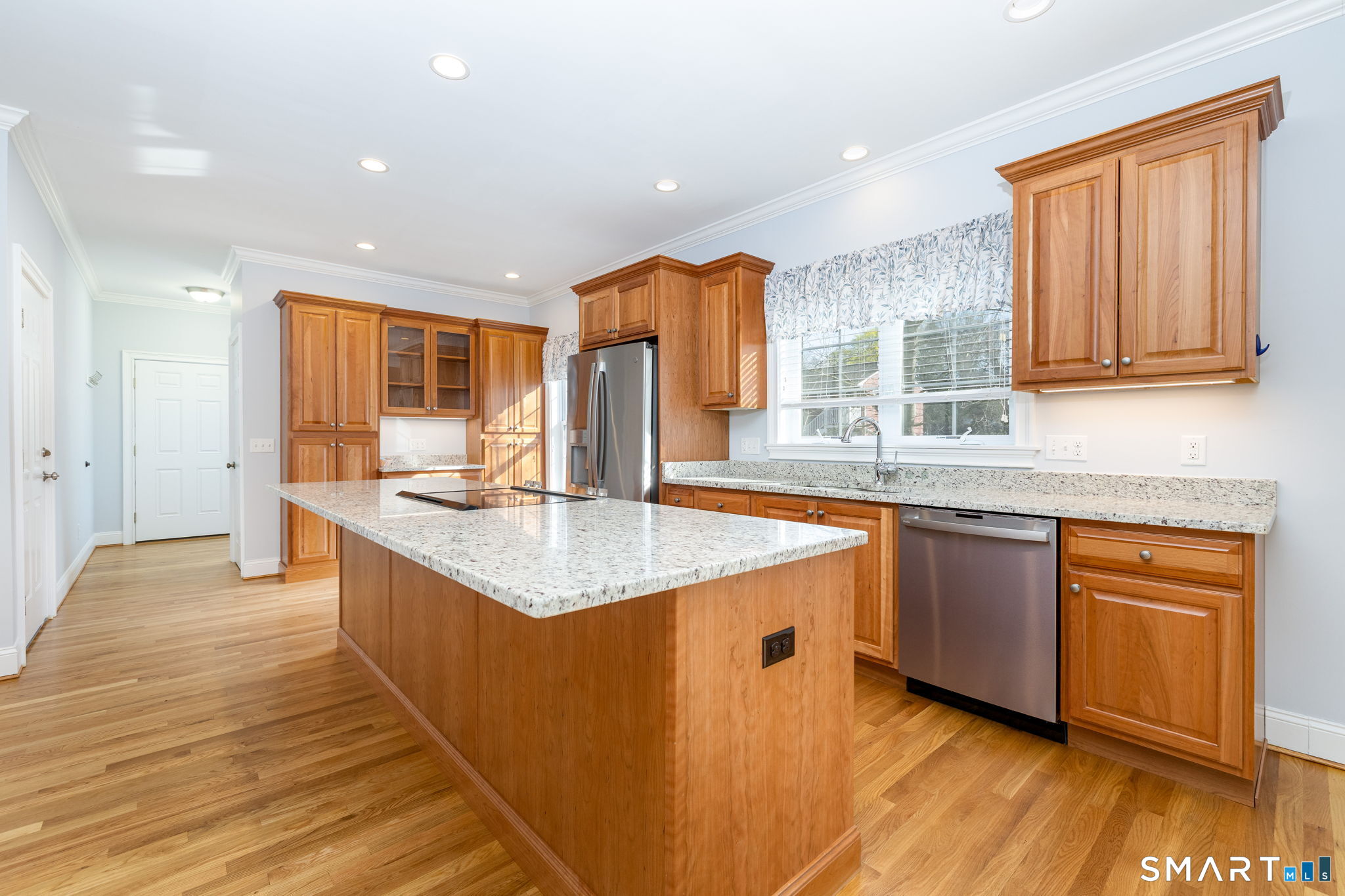 66 Kristyn Circle, Unit 66 Manchester, CT 06042 - Photo 7 of 26 a kitchen with stainless steel appliances granite countertop a sink and wooden cabinets