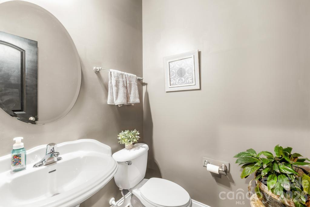 1007 Hamil Ridge Drive Waxhaw, NC 28173 - Photo 13 of 44 a bathroom with a sink mirror vanity and toilet