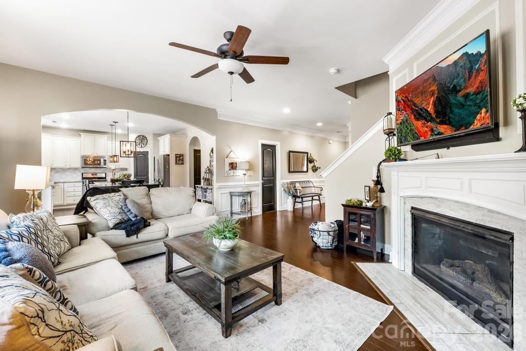 1007 Hamil Ridge Drive Waxhaw, NC 28173 - Photo 22 of 44 a living room with furniture a flat screen tv and a fireplace