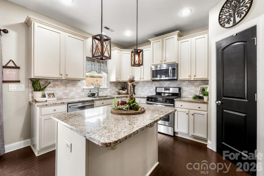 1007 Hamil Ridge Drive Waxhaw, NC 28173 - Photo 25 of 44 a kitchen with granite countertop stainless steel appliances a counter space and a refrigerator